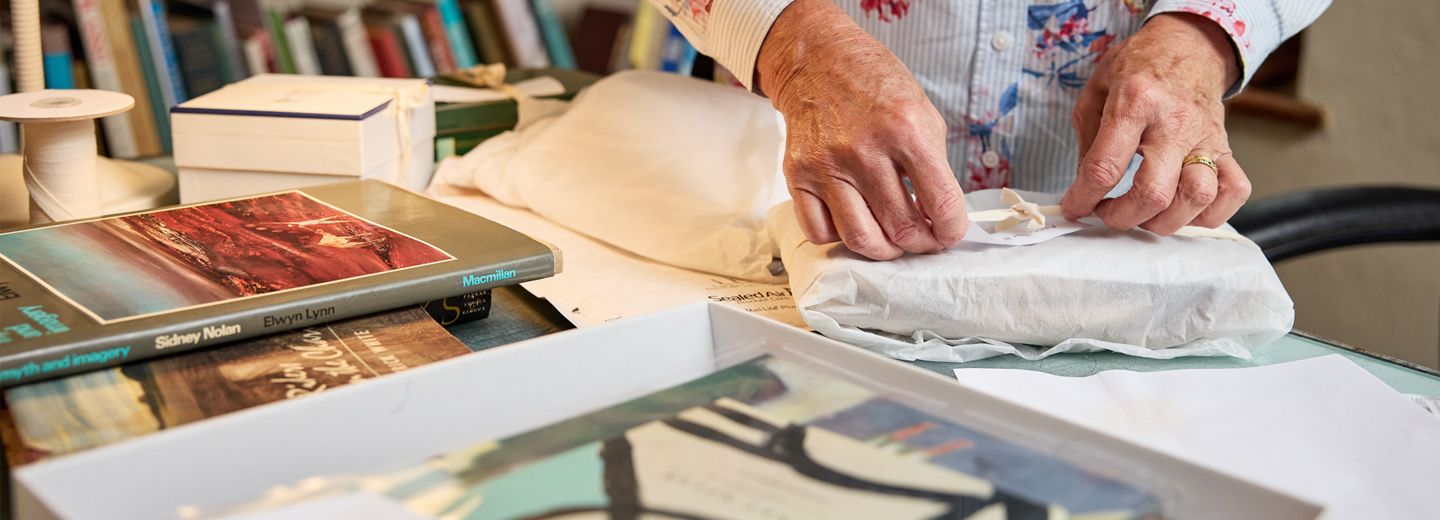 Volunteer working with Nolan archive materials 